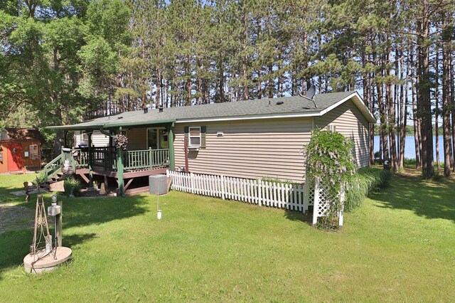 30348 422nd Ln, Aitkin, MN 56431 - back of house featuring a deck, a lawn, and a shingled roof