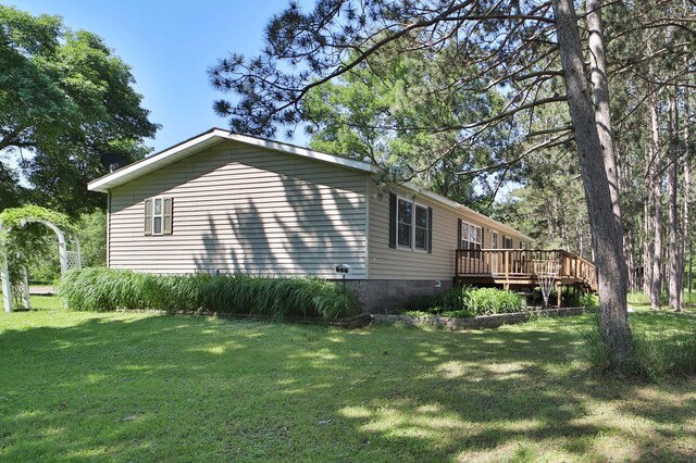 30348 422nd Ln, Aitkin, MN 56431 - view of side of home featuring a wooden deck, a yard, and crawl space