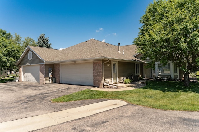 1954 Topaz Pointe Ln SW, Rochester, MN 55902 - single story home featuring brick siding, a front lawn, an attached garage, roof with shingles, and driveway
