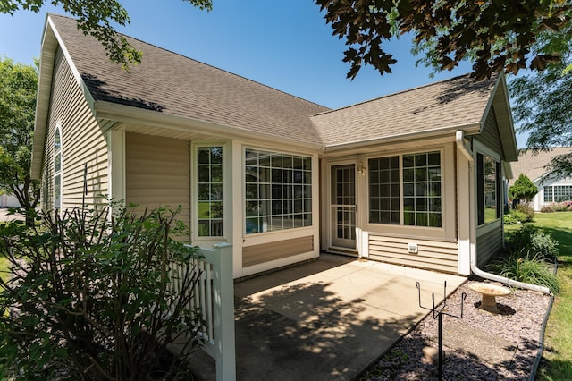 1954 Topaz Pointe Ln SW, Rochester, MN 55902 - rear view of house featuring a shingled roof and a patio