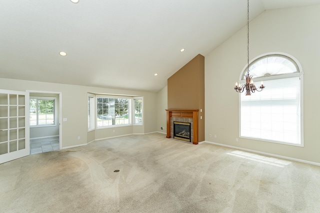 1954 Topaz Pointe Ln SW, Rochester, MN 55902 - unfurnished living room with a chandelier, light carpet, a tile fireplace, recessed lighting, and high vaulted ceiling