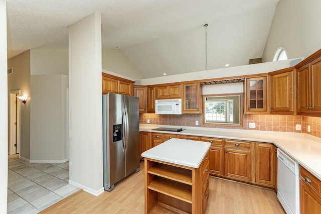 1954 Topaz Pointe Ln SW, Rochester, MN 55902 - kitchen with white appliances, brown cabinets, decorative backsplash, light countertops, and high vaulted ceiling