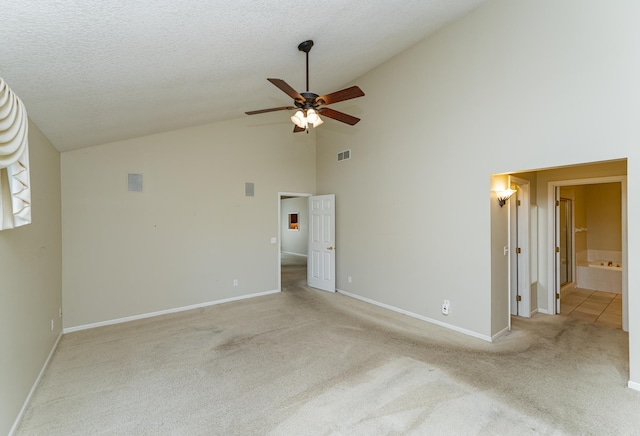 1954 Topaz Pointe Ln SW, Rochester, MN 55902 - unfurnished bedroom with high vaulted ceiling, light carpet, connected bathroom, and ceiling fan