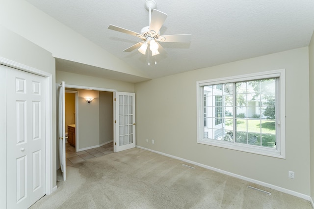 1954 Topaz Pointe Ln SW, Rochester, MN 55902 - spare room featuring light carpet, ceiling fan, lofted ceiling, and a textured ceiling