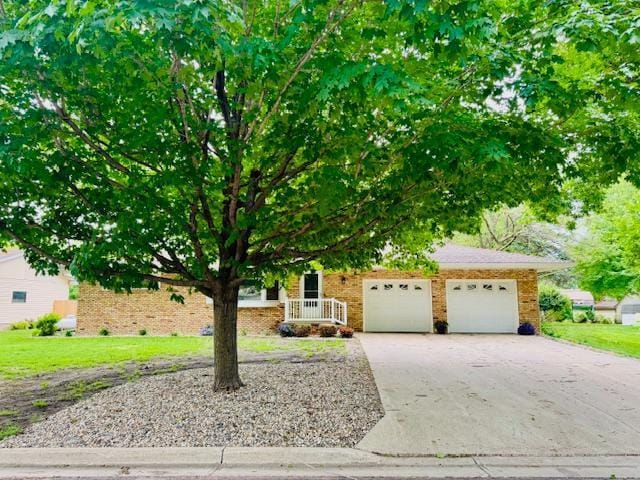 3033 Redwood Ave, Slayton, MN 56172 - obstructed view of property featuring concrete driveway and an attached garage