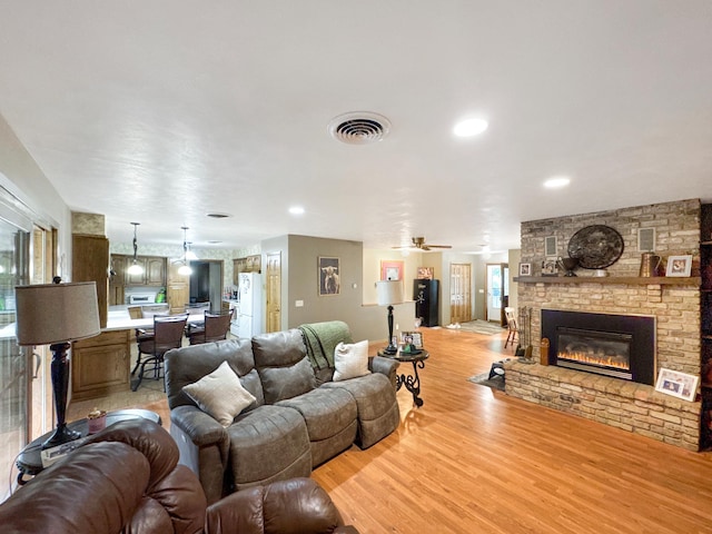 3033 Redwood Ave, Slayton, MN 56172 - living area featuring a fireplace, light wood-style flooring, recessed lighting, and a ceiling fan