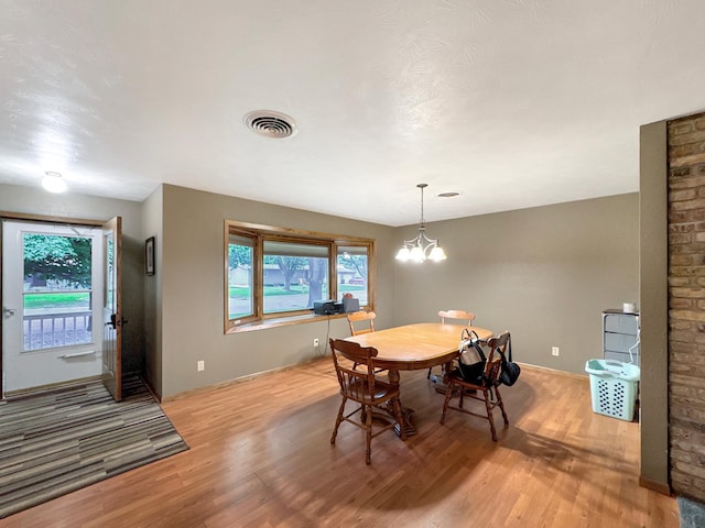 3033 Redwood Ave, Slayton, MN 56172 - dining space featuring light wood-style flooring and a chandelier