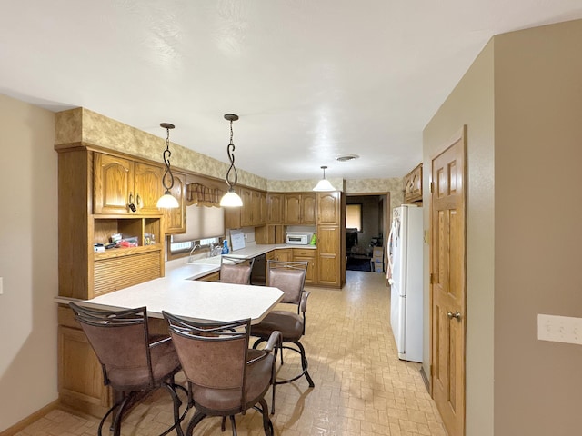 3033 Redwood Ave, Slayton, MN 56172 - kitchen with white appliances, a peninsula, light countertops, and brick patterned flooring