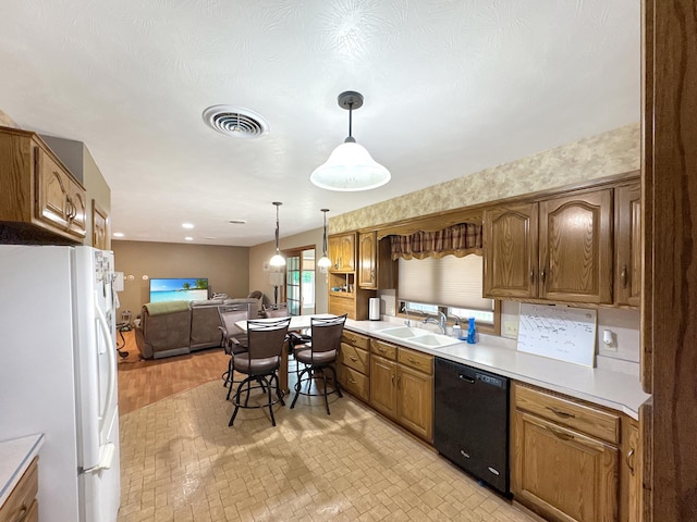 3033 Redwood Ave, Slayton, MN 56172 - kitchen featuring freestanding refrigerator, dishwasher, light countertops, open floor plan, and pendant lighting