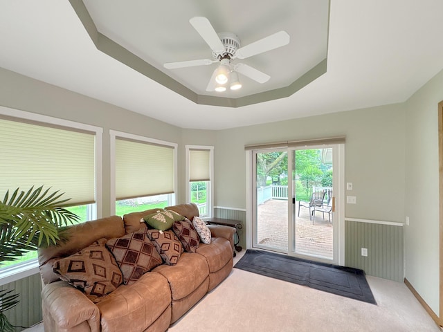 3033 Redwood Ave, Slayton, MN 56172 - living room with a tray ceiling, wainscoting, ceiling fan, and carpet flooring