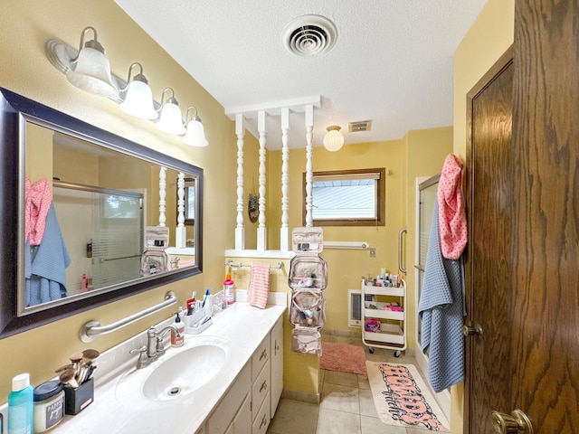3033 Redwood Ave, Slayton, MN 56172 - bathroom featuring a stall shower, vanity, tile patterned floors, and a textured ceiling
