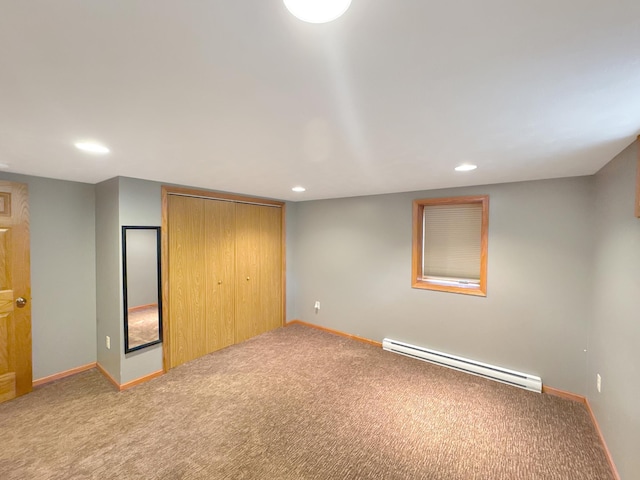3033 Redwood Ave, Slayton, MN 56172 - unfurnished bedroom with a baseboard radiator, carpet flooring, a closet, and recessed lighting