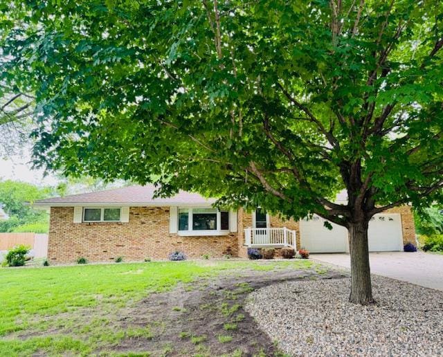3033 Redwood Ave, Slayton, MN 56172 - view of property hidden behind natural elements with brick siding, driveway, and a garage