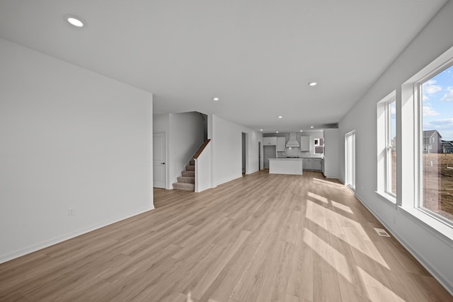 TBB Trinity, Shakopee, MN 55379 - unfurnished living room with healthy amount of natural light, light wood-type flooring, stairway, and recessed lighting