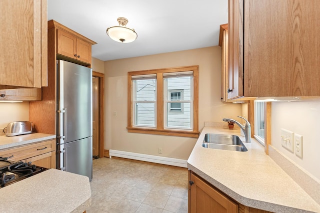 275 Pascal St S, Saint Paul, MN 55105 - kitchen featuring a baseboard radiator, freestanding refrigerator, light countertops, brown cabinets, and cooktop