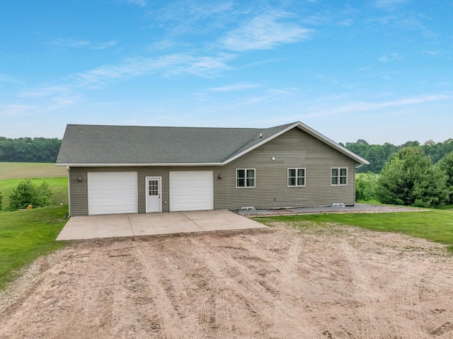615 18th St, Prairie Lake Twp, WI 54728 - view of front of home featuring dirt driveway, a garage, a front lawn, and roof with shingles