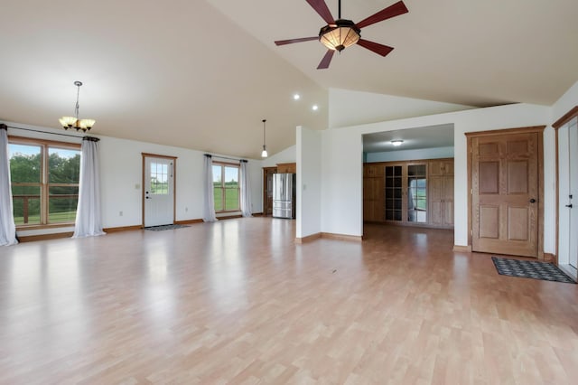 615 18th St, Prairie Lake Twp, WI 54728 - unfurnished living room featuring a chandelier, a ceiling fan, light wood-style flooring, and high vaulted ceiling
