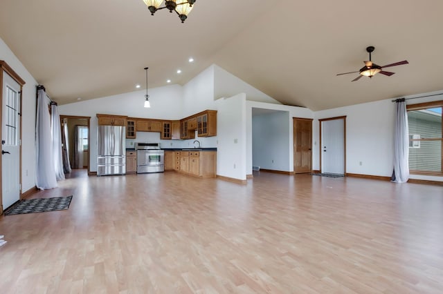 615 18th St, Prairie Lake Twp, WI 54728 - unfurnished living room featuring light wood-type flooring, high vaulted ceiling, a ceiling fan, a chandelier, and healthy amount of natural light