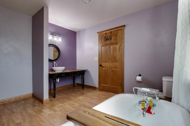 615 18th St, Prairie Lake Twp, WI 54728 - bathroom with wood finished floors and a freestanding tub