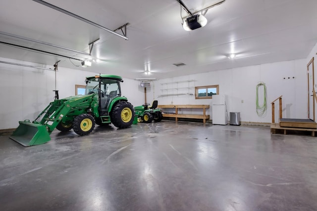 615 18th St, Prairie Lake Twp, WI 54728 - garage with freestanding refrigerator and a garage door opener
