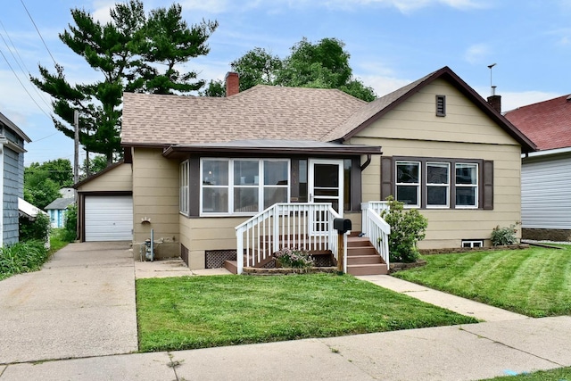 663 Wilson St, Winona, MN 55987 - bungalow featuring a chimney, roof with shingles, concrete driveway, a garage, and a front yard
