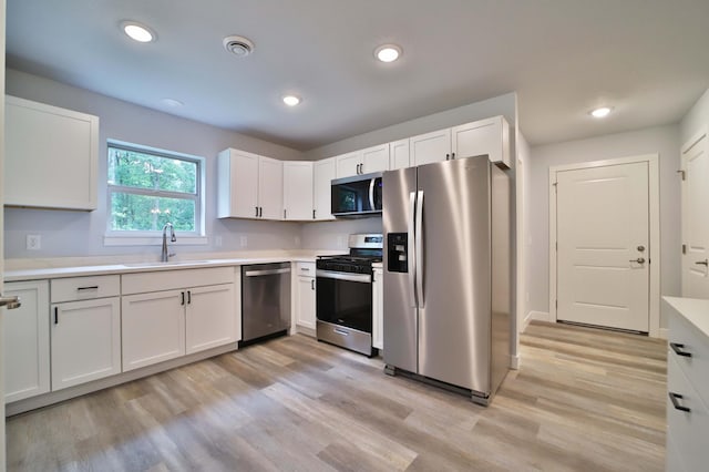 14729 Wildflower Dr, Baxter, MN 56425 - kitchen featuring stainless steel appliances, light wood-type flooring, light countertops, white cabinetry, and recessed lighting