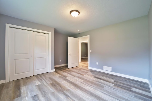 14729 Wildflower Dr, Baxter, MN 56425 - unfurnished bedroom with light wood-type flooring and a closet