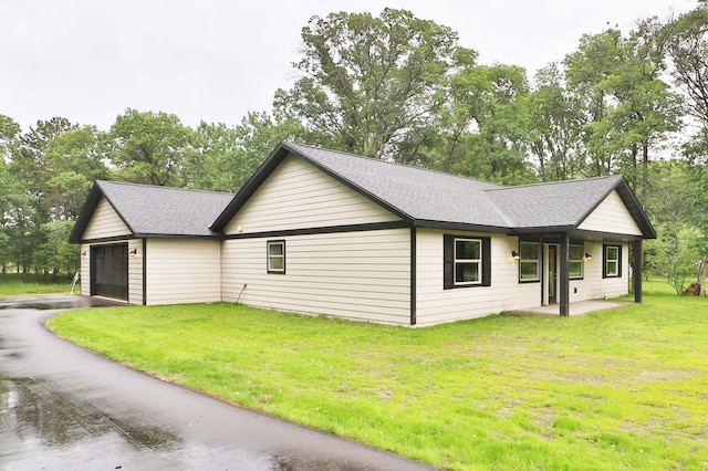 14729 Wildflower Dr, Baxter, MN 56425 - view of property exterior featuring roof with shingles, a yard, driveway, and view of scattered trees