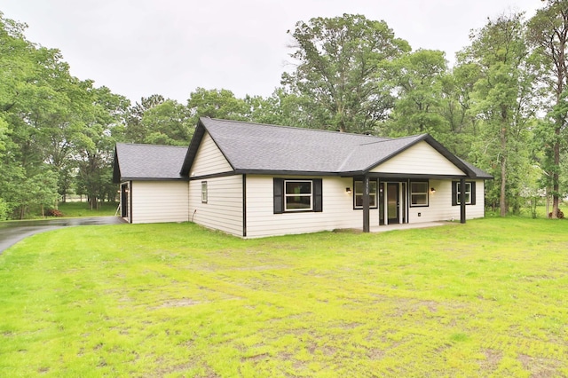 14729 Wildflower Dr, Baxter, MN 56425 - view of front of property with a front yard, a shingled roof, and view of wooded area