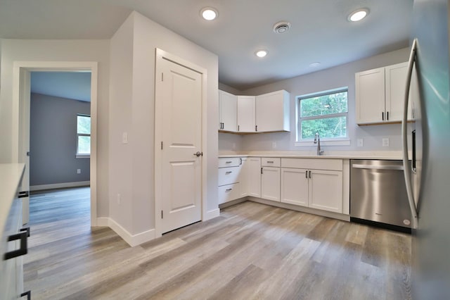 14729 Wildflower Dr, Baxter, MN 56425 - kitchen featuring stainless steel appliances, light wood-style floors, white cabinetry, light countertops, and recessed lighting