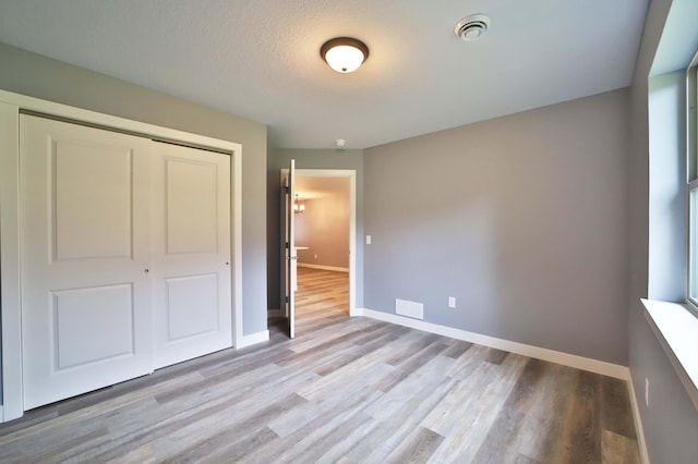 14729 Wildflower Dr, Baxter, MN 56425 - unfurnished bedroom with a closet and light wood-style flooring
