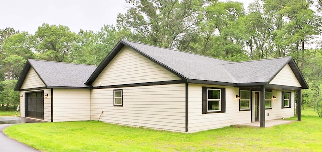 14729 Wildflower Dr, Baxter, MN 56425 - view of home's exterior featuring roof with shingles, a yard, a garage, and driveway