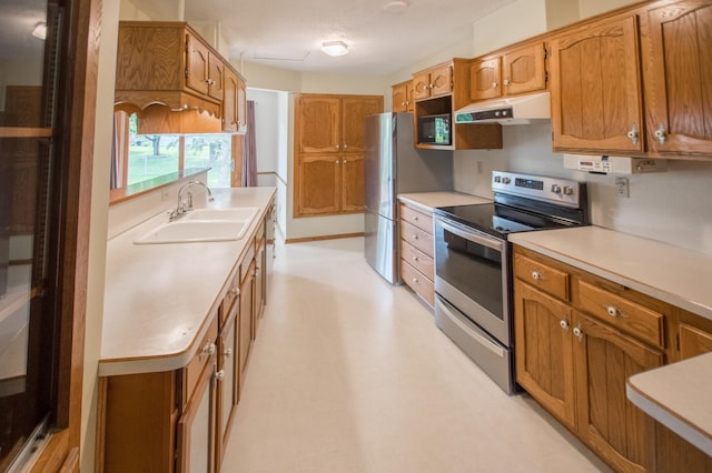 12423 93rd Ave N, Maple Grove, MN 55369 - kitchen featuring appliances with stainless steel finishes, under cabinet range hood, light countertops, and brown cabinets