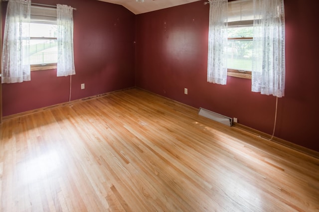 12423 93rd Ave N, Maple Grove, MN 55369 - empty room featuring wood finished floors and lofted ceiling