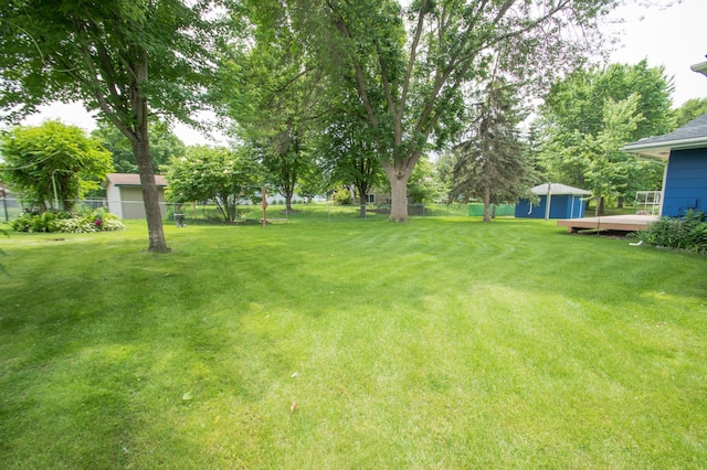 12423 93rd Ave N, Maple Grove, MN 55369 - view of yard with a shed and a wooden deck