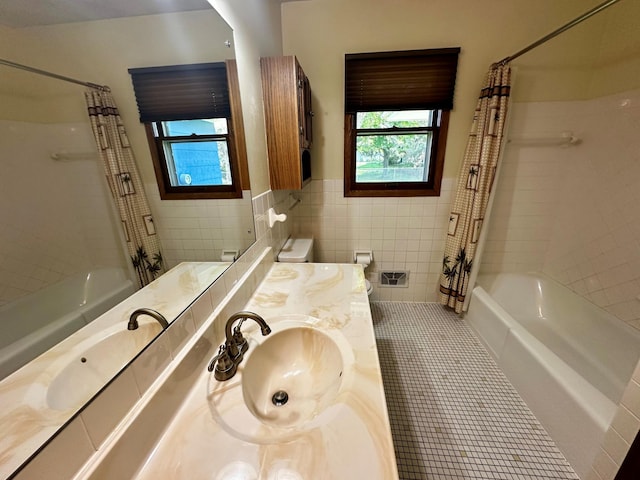 12423 93rd Ave N, Maple Grove, MN 55369 - full bathroom featuring shower / tub combo, vanity, tile walls, wainscoting, and tile patterned flooring