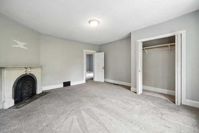 870 Clark St, Saint Paul, MN 55130 - unfurnished living room featuring carpet flooring, crown molding, a fireplace with flush hearth, and a textured ceiling