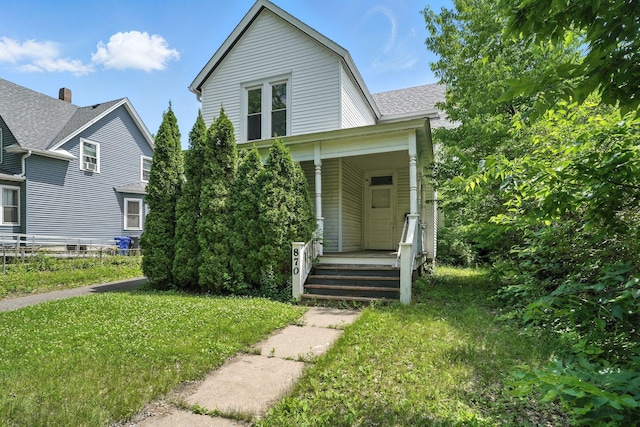 870 Clark St, Saint Paul, MN 55130 - view of front of property with covered porch, a front lawn, and a shingled roof