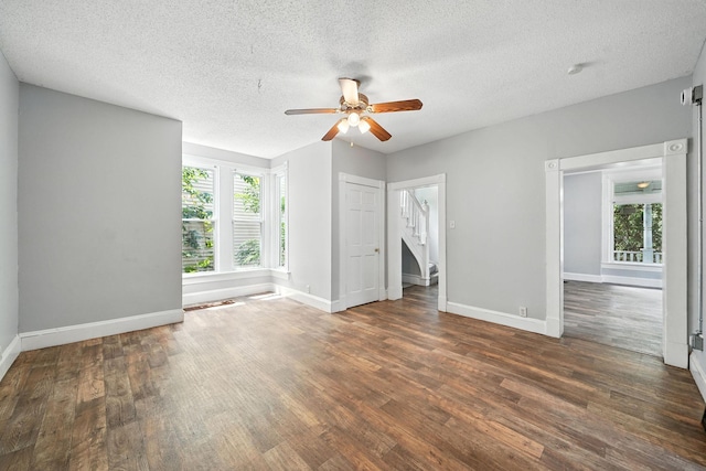 870 Clark St, Saint Paul, MN 55130 - empty room with ceiling fan, wood finished floors, stairs, and a textured ceiling