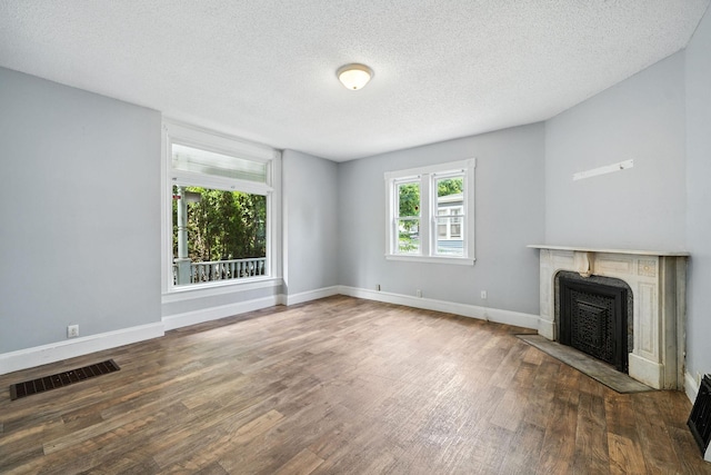 870 Clark St, Saint Paul, MN 55130 - unfurnished living room featuring wood finished floors, a fireplace, and a textured ceiling