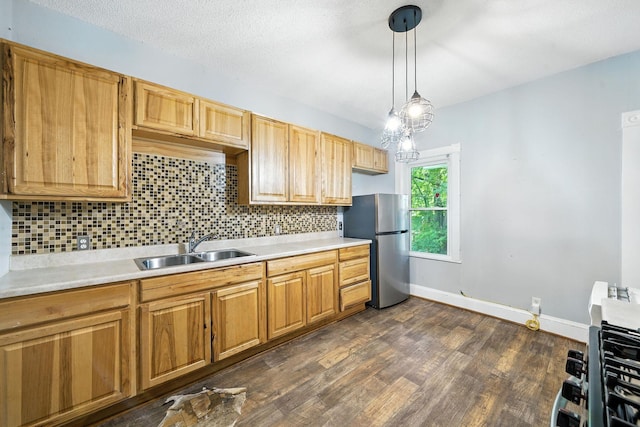 870 Clark St, Saint Paul, MN 55130 - kitchen featuring freestanding refrigerator, light countertops, tasteful backsplash, dark wood finished floors, and decorative light fixtures