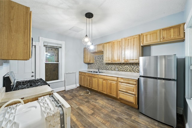 870 Clark St, Saint Paul, MN 55130 - kitchen featuring freestanding refrigerator, light countertops, dark wood-style flooring, backsplash, and black range with gas cooktop