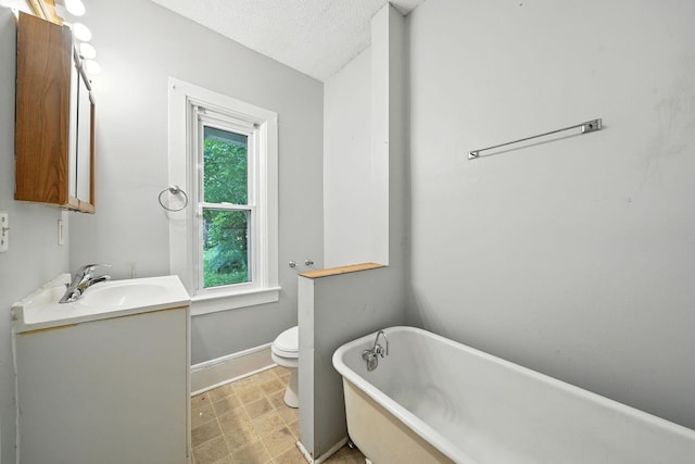870 Clark St, Saint Paul, MN 55130 - bathroom featuring a freestanding tub, vanity, and a textured ceiling