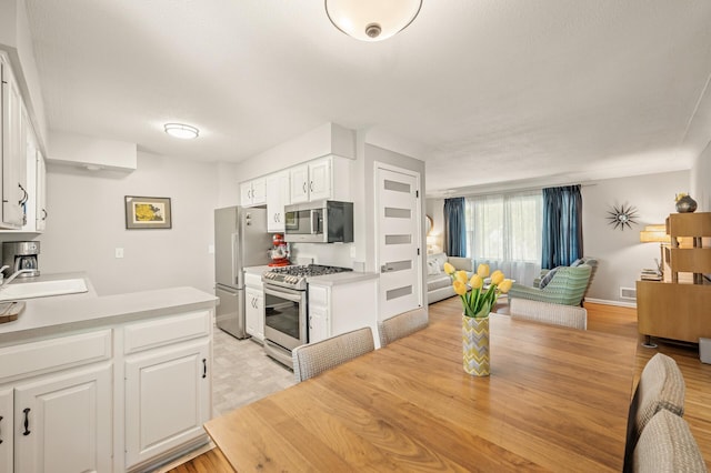 3420 Parkview Blvd, Robbinsdale, MN 55422 - dining area with light wood finished floors and baseboards