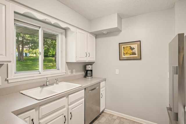 3420 Parkview Blvd, Robbinsdale, MN 55422 - kitchen with stainless steel appliances, white cabinets, light countertops, and a textured ceiling