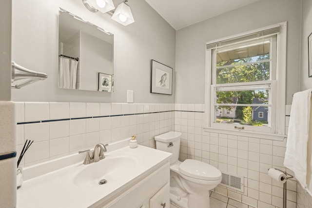 3420 Parkview Blvd, Robbinsdale, MN 55422 - bathroom with tile walls, vanity, tile patterned floors, and wainscoting