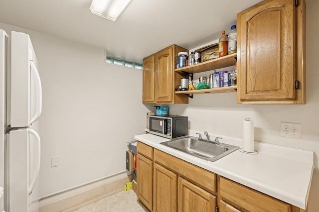 3420 Parkview Blvd, Robbinsdale, MN 55422 - kitchen with freestanding refrigerator, light countertops, and brown cabinetry