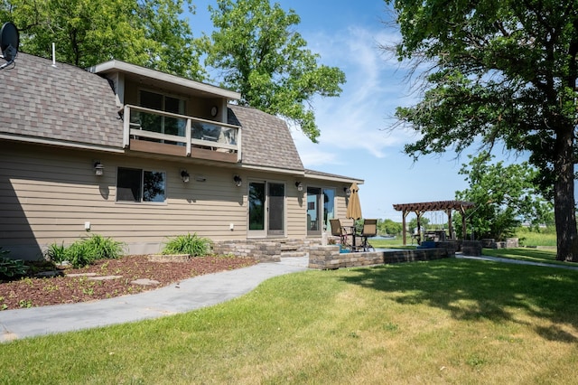 403 Riverview Dr SE, Warroad, MN 56763 - rear view of house with a balcony, a pergola, a shingled roof, and a yard