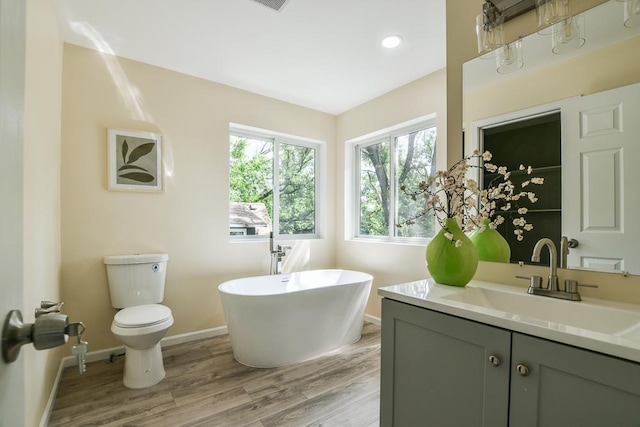 4220 Brookside Ave, Saint Louis Park, MN 55416 - full bathroom featuring vanity, a soaking tub, wood finished floors, and recessed lighting
