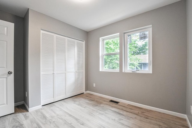 4220 Brookside Ave, Saint Louis Park, MN 55416 - unfurnished bedroom featuring light wood finished floors and a closet